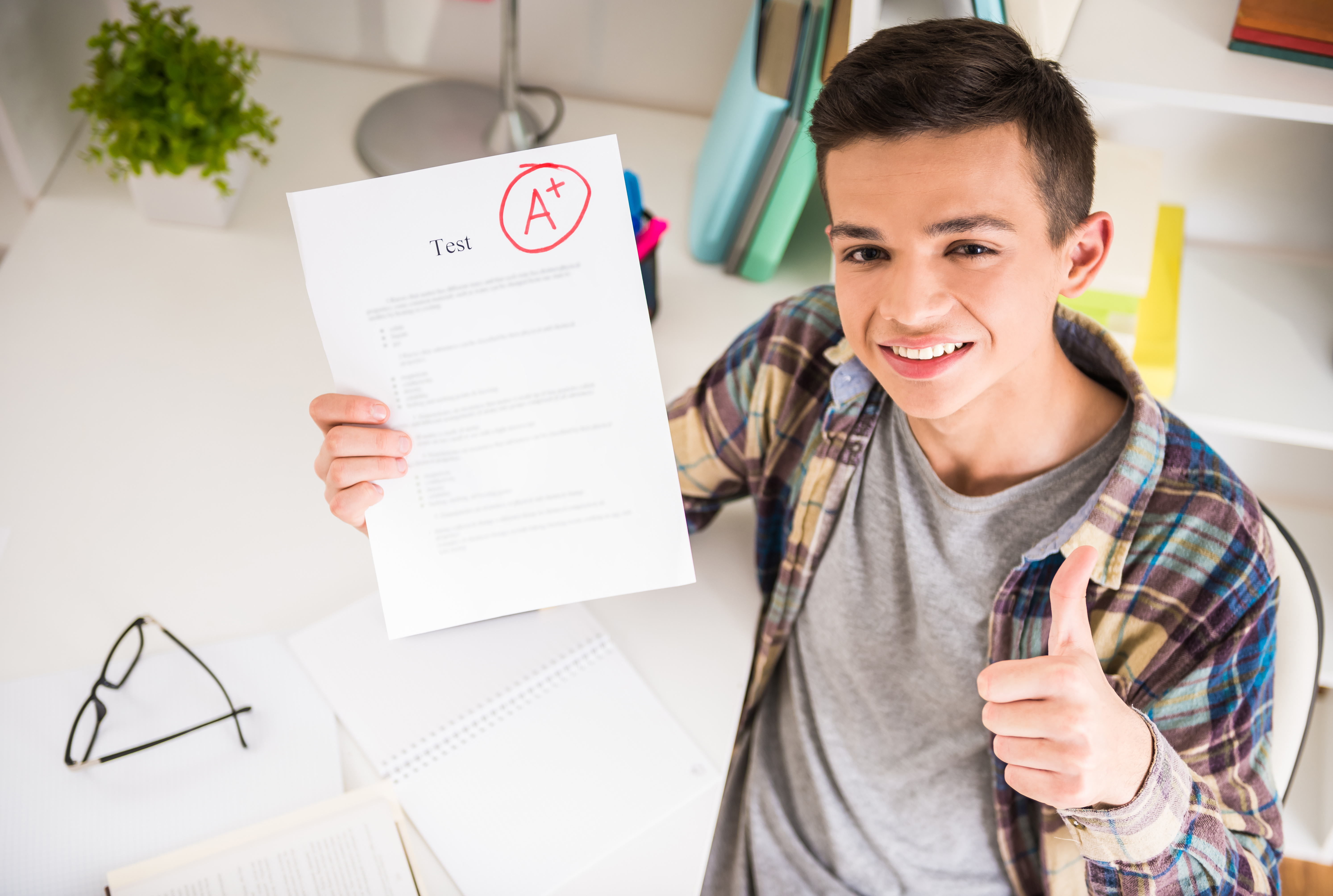 boy holding paper with good grade